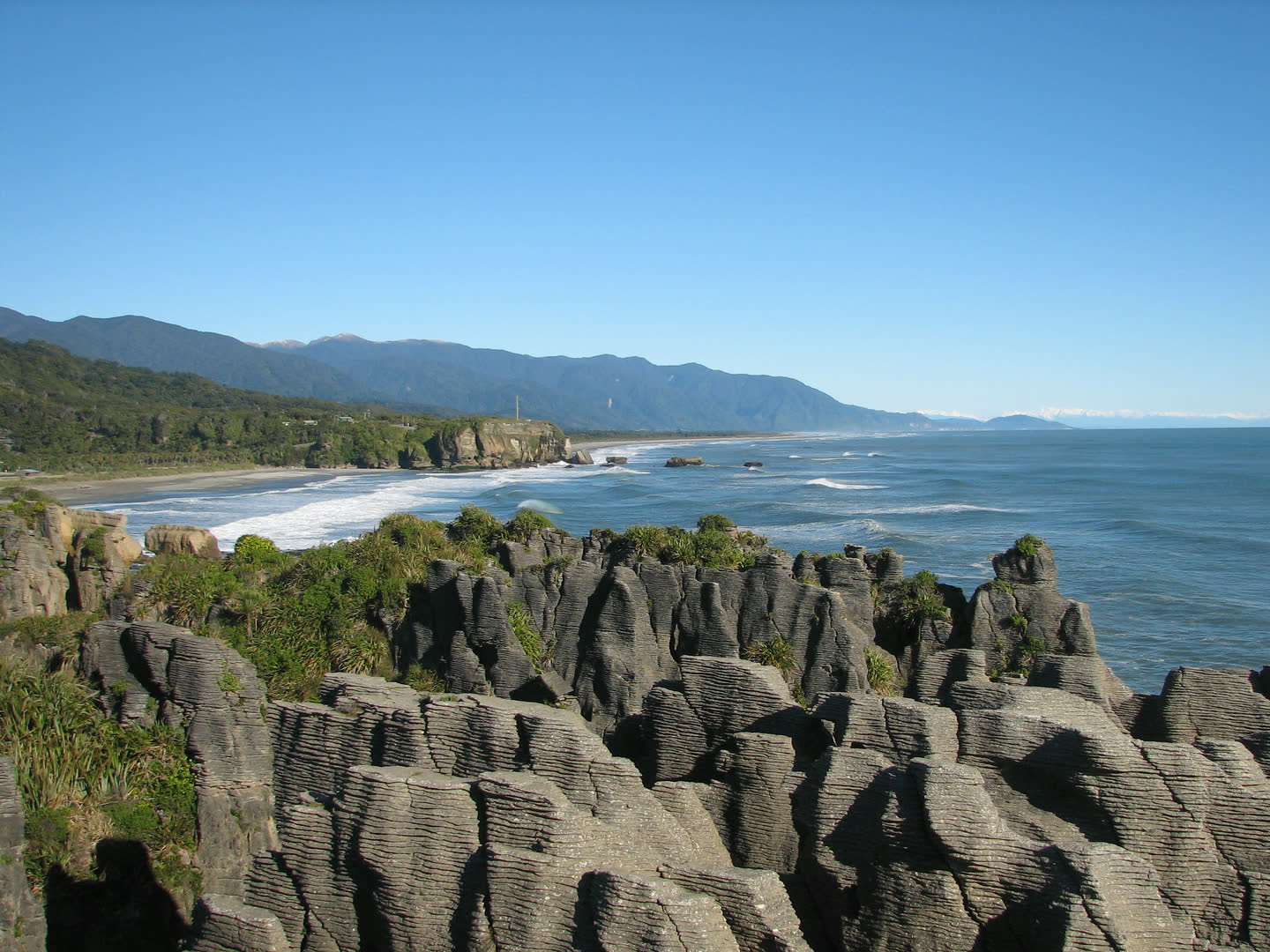 Limestone coastal rocks, surf and forested ranges at Punakaiki